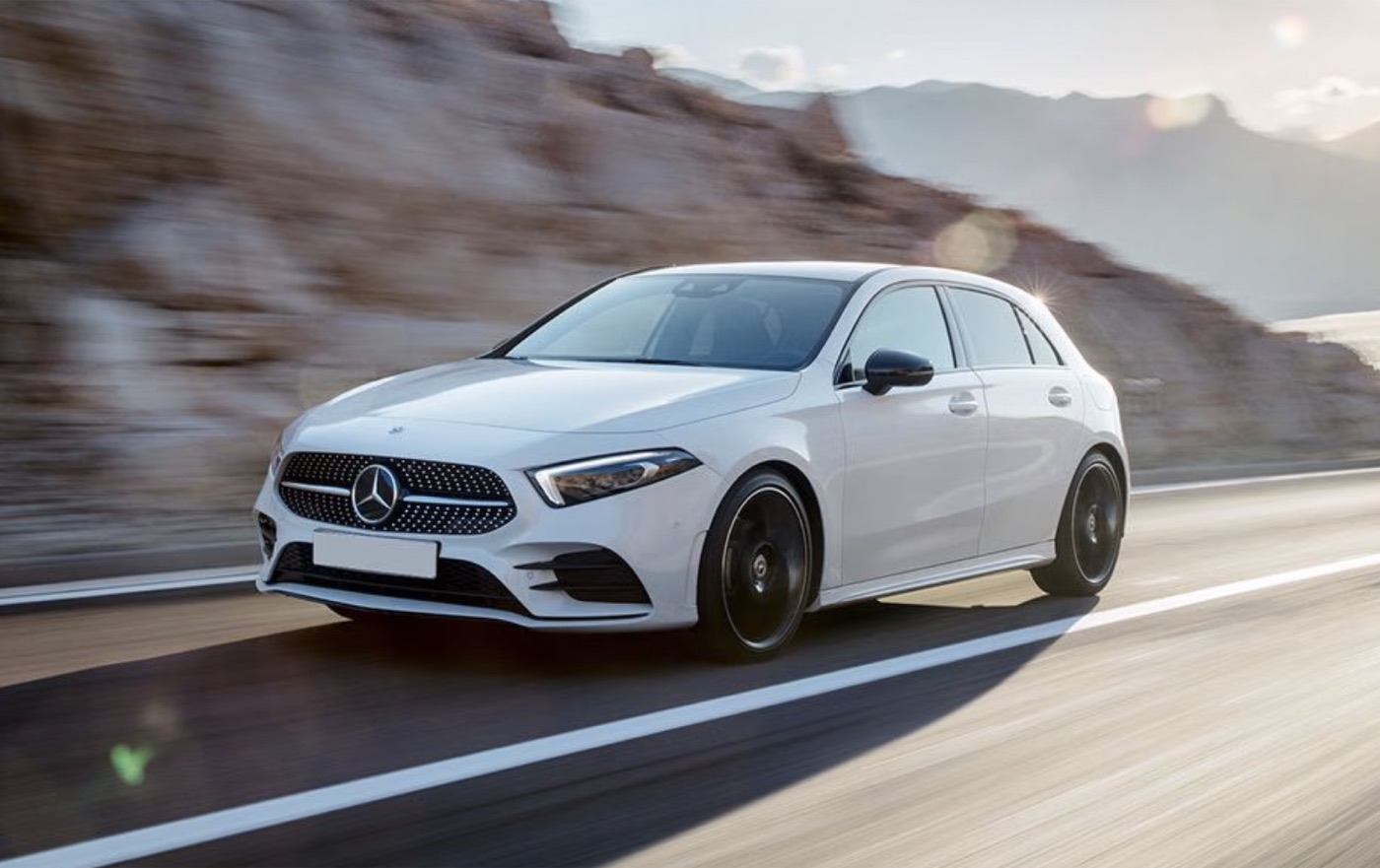 White Mercedes hatch in motion on the road